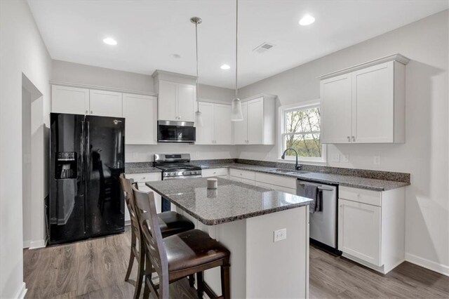 822 Pine Way, Dallas, GA 30157 - kitchen with white cabinets, a sink, a center island, and appliances with stainless steel finishes