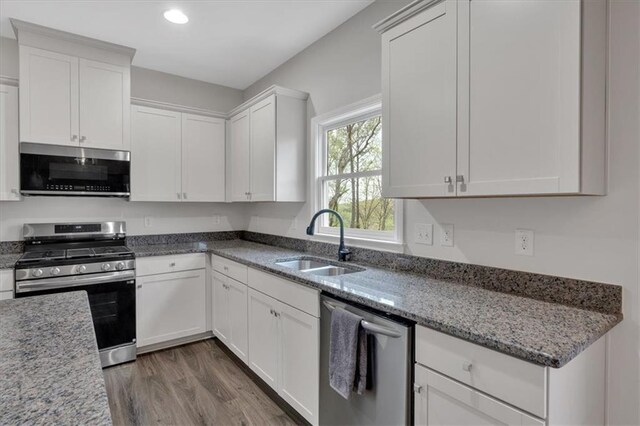 822 Pine Way, Dallas, GA 30157 - kitchen with a sink, white cabinets, light stone countertops, appliances with stainless steel finishes, and wood finished floors