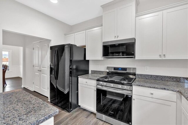 822 Pine Way, Dallas, GA 30157 - kitchen featuring white cabinets, light stone countertops, stainless steel appliances, and light wood-type flooring