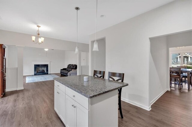 822 Pine Way, Dallas, GA 30157 - kitchen featuring a center island, white cabinets, wood finished floors, and a breakfast bar