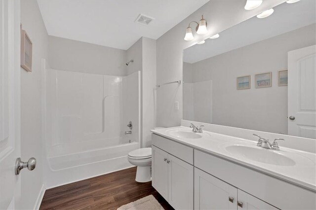 822 Pine Way, Dallas, GA 30157 - bathroom with visible vents, a sink, toilet, and wood finished floors
