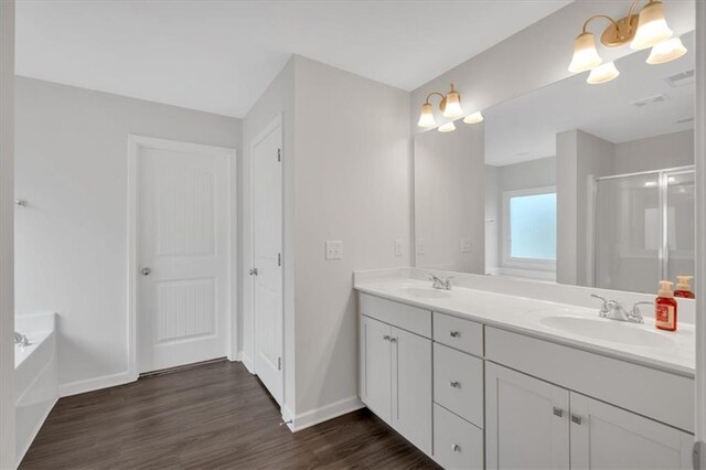 822 Pine Way, Dallas, GA 30157 - bathroom with a stall shower, a sink, wood finished floors, baseboards, and double vanity