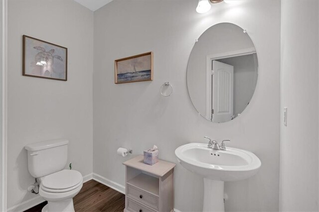822 Pine Way, Dallas, GA 30157 - bathroom featuring baseboards, toilet, a sink, and wood finished floors