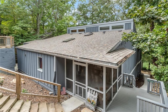 114 Narrows Loop, Waleska, GA 30183 - back of property with roof with shingles, a sunroom, a wooden deck, board and batten siding, and view of scattered trees