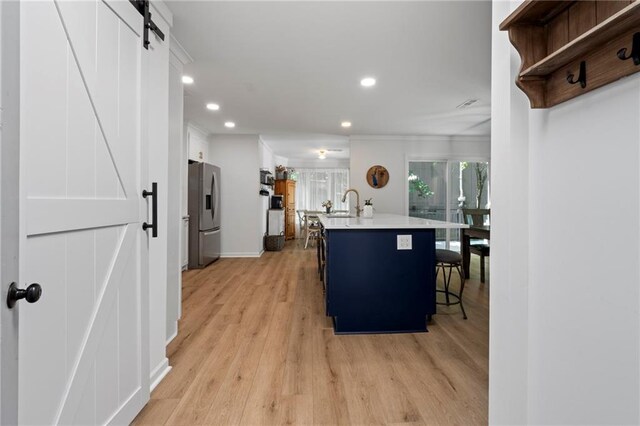114 Narrows Loop, Waleska, GA 30183 - kitchen with a barn door, stainless steel refrigerator with ice dispenser, recessed lighting, light wood-style floors, and light countertops