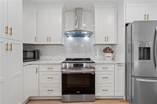 114 Narrows Loop, Waleska, GA 30183 - kitchen featuring appliances with stainless steel finishes, wall chimney range hood, white cabinets, light stone counters, and decorative backsplash