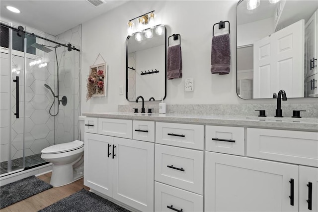 114 Narrows Loop, Waleska, GA 30183 - bathroom featuring double vanity, a stall shower, wood finished floors, and toilet