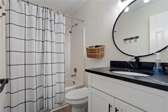 114 Narrows Loop, Waleska, GA 30183 - full bath with vanity, toilet, shower / bath combination with curtain, a textured wall, and wood finished floors