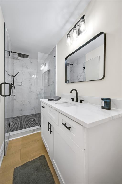 1830 Mayfield Rd, Alpharetta, GA 30009 - full bathroom with a marble finish shower, vanity, and wood finished floors