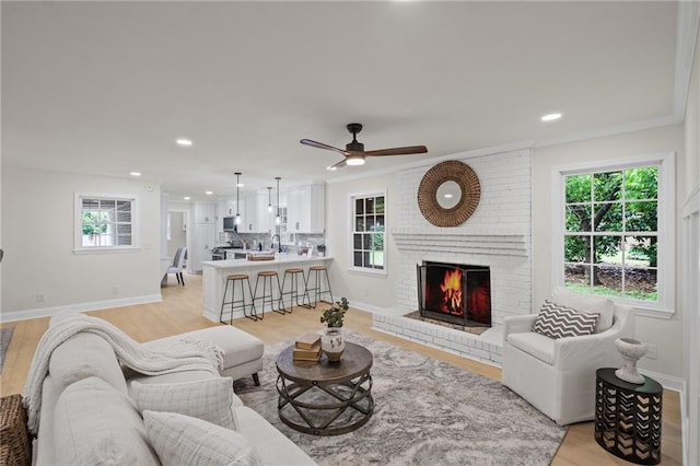 1830 Mayfield Rd, Alpharetta, GA 30009 - living area with plenty of natural light, a fireplace, baseboards, light wood finished floors, and recessed lighting