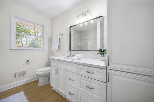 1830 Mayfield Rd, Alpharetta, GA 30009 - full bathroom featuring a marble finish shower, double vanity, toilet, wood finished floors, and baseboards