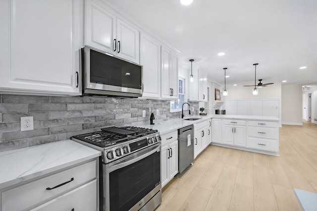 1830 Mayfield Rd, Alpharetta, GA 30009 - kitchen featuring stainless steel appliances, ceiling fan, a sink, a peninsula, and tasteful backsplash