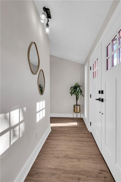 garage featuring a garage door opener and baseboards