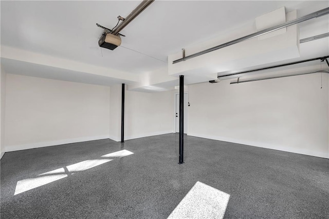 garage with a garage door opener and baseboards