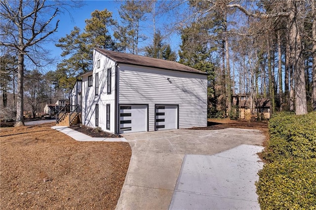view of home's exterior with concrete driveway