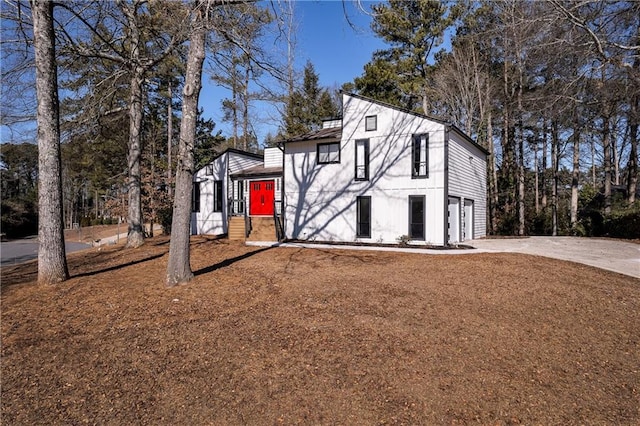 view of front of home with concrete driveway and an attached garage