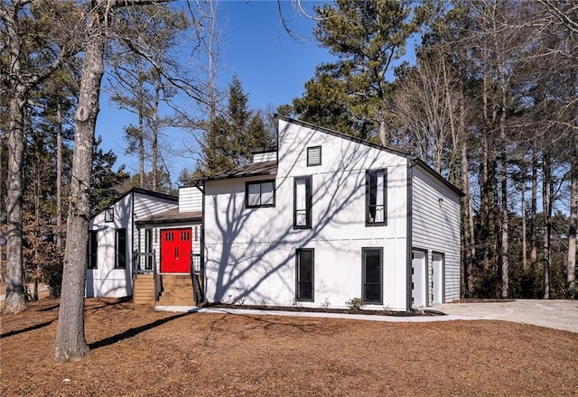 view of front of house with concrete driveway and an attached garage