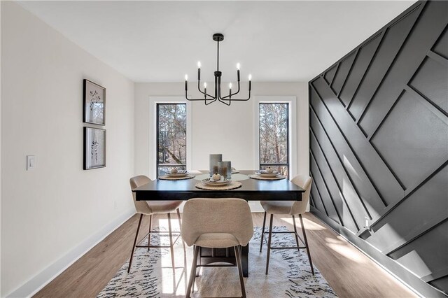 living area with light wood-style flooring, baseboards, beamed ceiling, a ceiling fan, and high vaulted ceiling