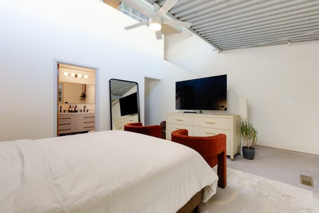 bedroom featuring visible vents, a ceiling fan, ensuite bath, carpet flooring, and baseboards