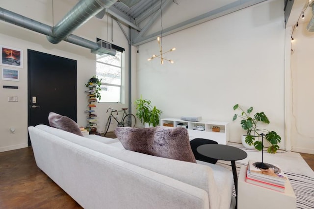 living room with wood finished floors, baseboards, and a chandelier