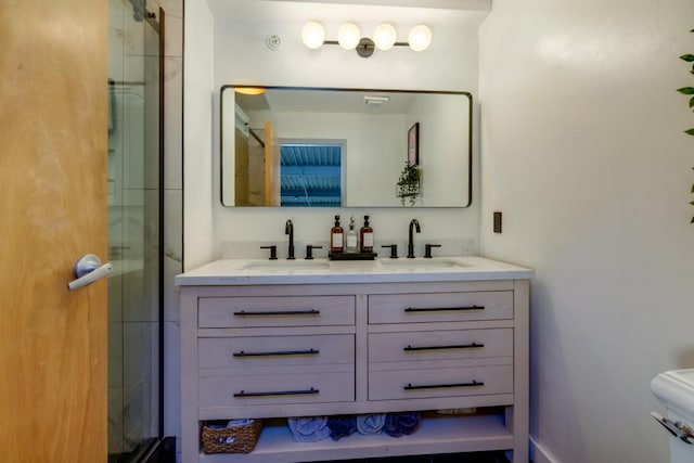 full bath with a sink, a stall shower, and double vanity