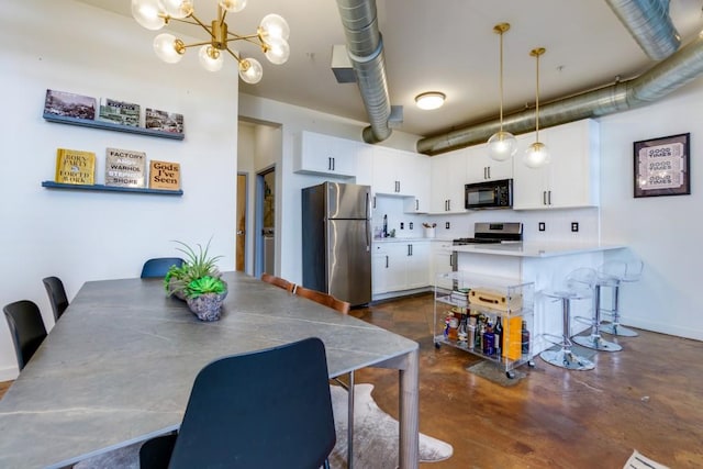 dining room featuring a notable chandelier, baseboards, and concrete floors