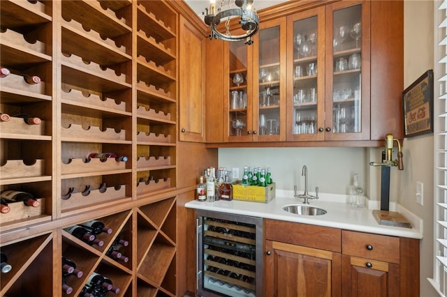 wine area featuring wet bar, a sink, and beverage cooler