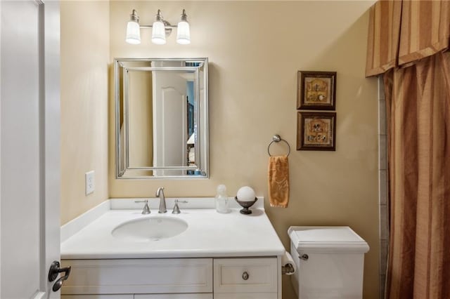 bathroom with toilet and vanity