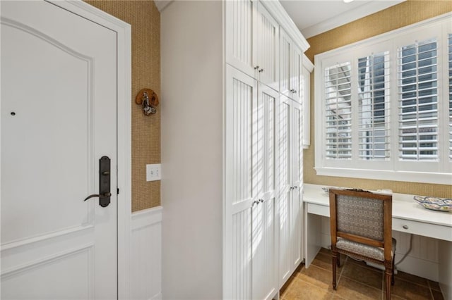 interior space with a wainscoted wall and light tile patterned flooring