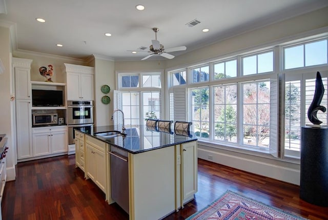 kitchen featuring a sink, ceiling fan, appliances with stainless steel finishes, dark wood-style floors, and crown molding