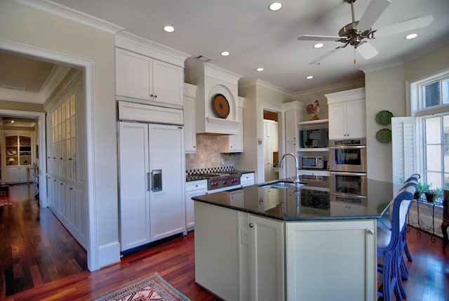 kitchen featuring a sink, ornamental molding, white cabinets, and appliances with stainless steel finishes