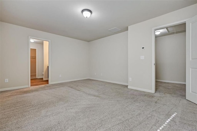 unfurnished bedroom featuring a closet and light colored carpet