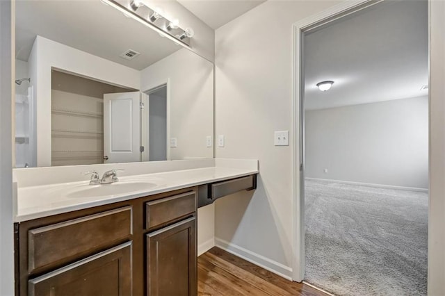 bathroom featuring hardwood / wood-style flooring and vanity