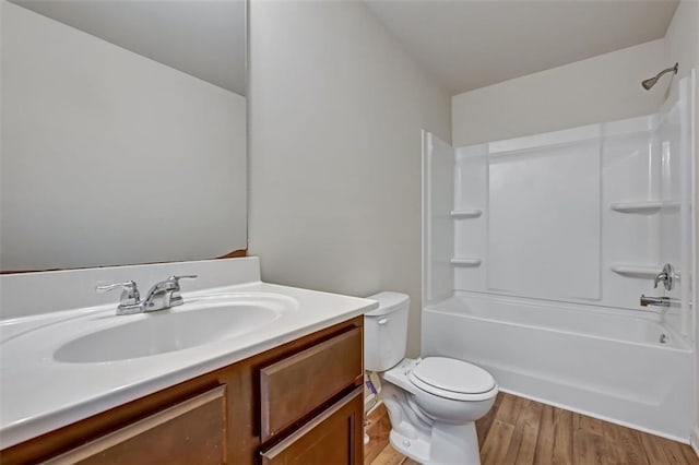 full bathroom featuring hardwood / wood-style flooring, vanity, toilet, and bathtub / shower combination