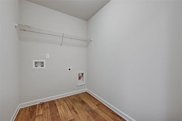 washroom with hardwood / wood-style floors, hookup for an electric dryer, and washer hookup