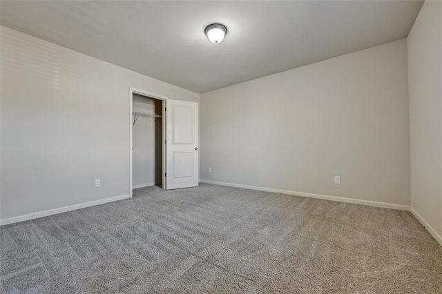 unfurnished bedroom with carpet floors and a closet