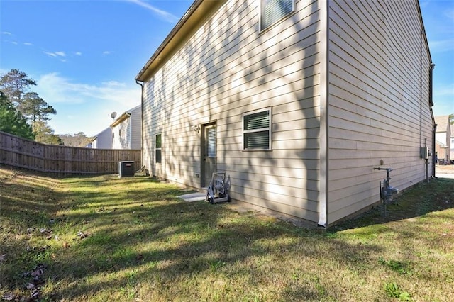 view of home's exterior featuring a yard and central air condition unit