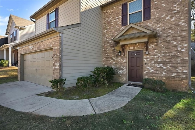 doorway to property with a garage