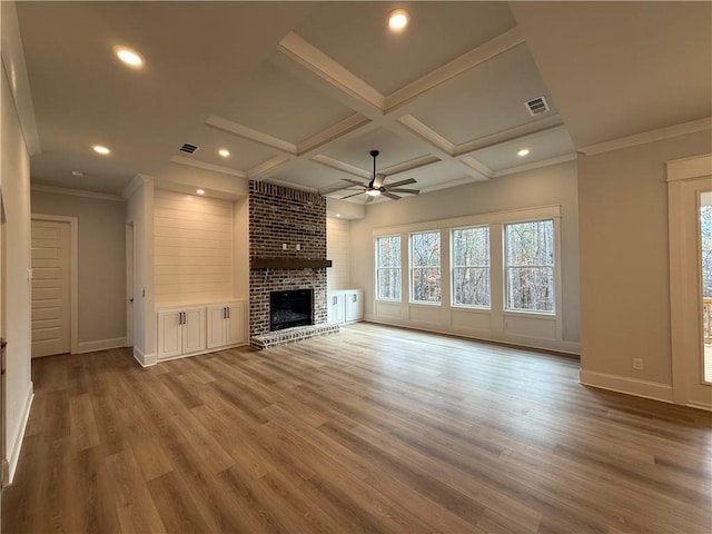 unfurnished living room with ceiling fan, a fireplace, wood-type flooring, and coffered ceiling