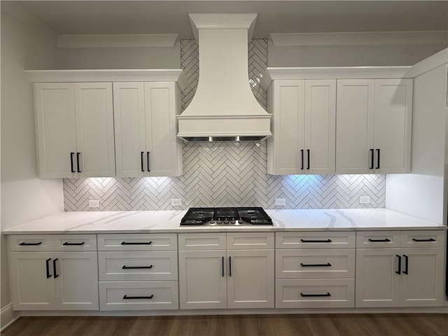 kitchen with backsplash, dark hardwood / wood-style floors, premium range hood, and stainless steel gas cooktop