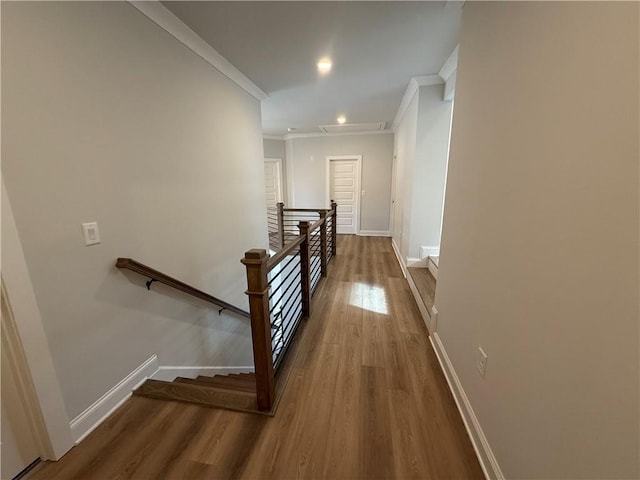 hall with hardwood / wood-style floors and ornamental molding