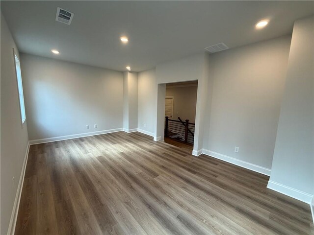 unfurnished room with dark hardwood / wood-style flooring