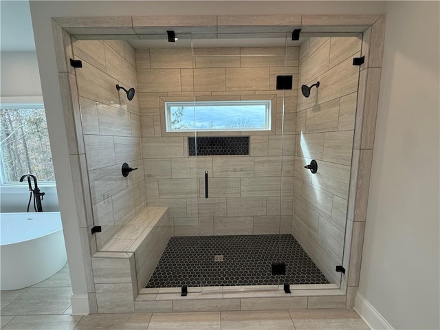 bathroom featuring tile patterned floors, plenty of natural light, and independent shower and bath