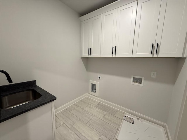 laundry room featuring electric dryer hookup, cabinets, sink, and hookup for a washing machine