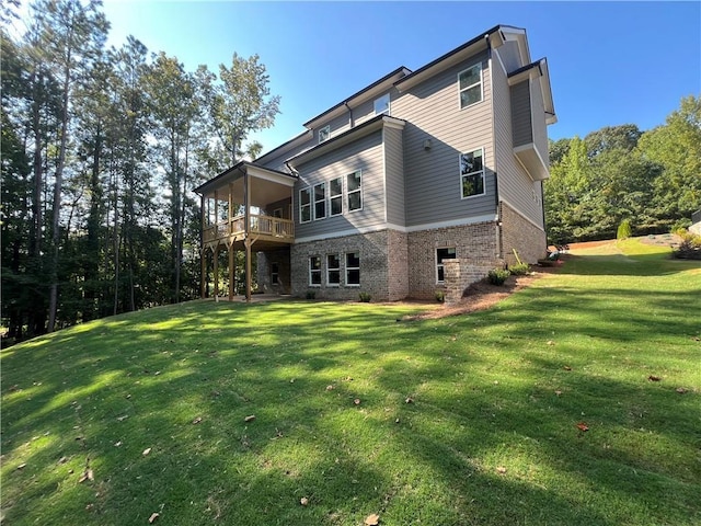 rear view of house with a yard and a balcony