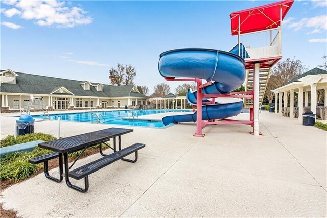 view of swimming pool with a water slide