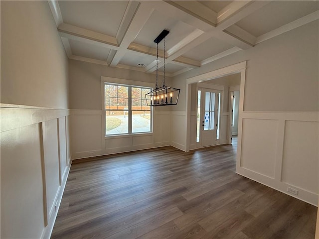 unfurnished dining area with coffered ceiling, crown molding, beamed ceiling, dark hardwood / wood-style flooring, and a chandelier