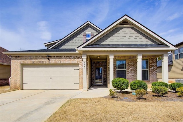 view of front facade with brick siding, driveway, and a garage