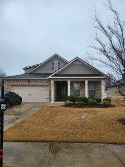 view of front facade with a garage, concrete driveway, and brick siding