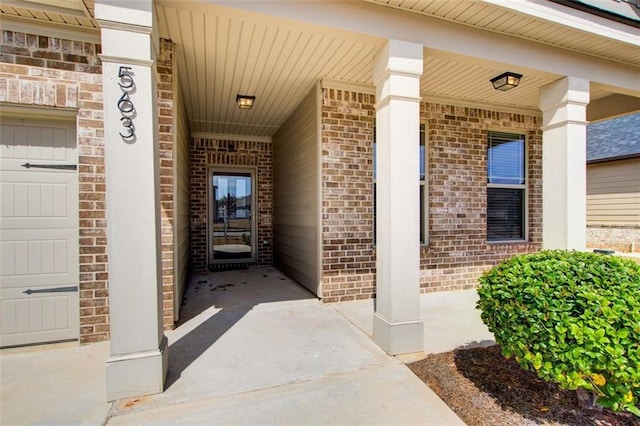 view of exterior entry with brick siding